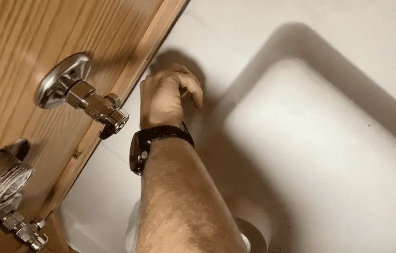 Tightening the nuts by hand under the sink